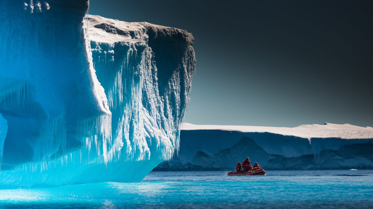 Small expedition tender by the iceberg