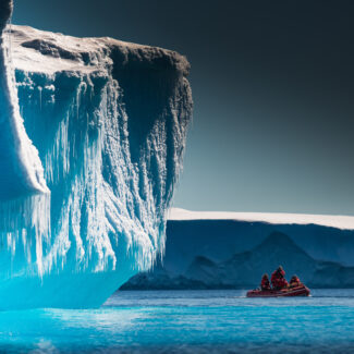 Small expedition tender by the iceberg