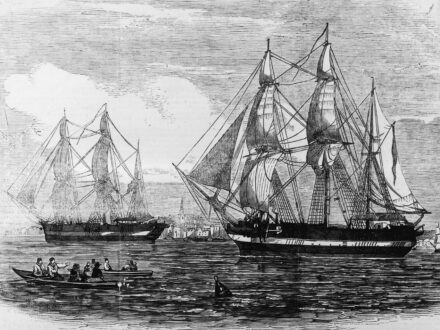 Black and white illustration of two large sailing ships on a body of water, with a smaller boat carrying several people in the foreground.
